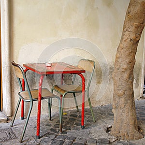 A Table And Chairs On the stereet