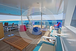 Table and chairs on stern sun deck of a luxury motor yacht