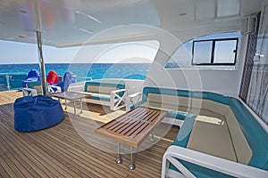 Table and chairs on stern sun deck of a luxury motor yacht