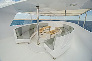 Table and chairs on sundeck of a luxury motor yacht