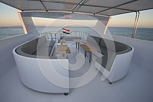 Table and chairs on sundeck of a luxury motor yacht