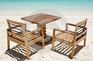 Table with chairs at the tropical beach at Maldives