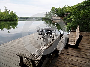 Table, Chairs and Wood Bench on Lake Dock