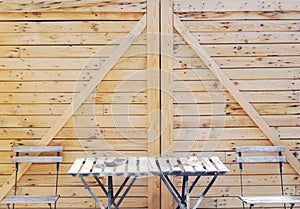 Table, chairs and wood wall