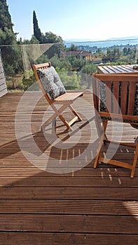 table chairs wooden in wooden balcony with gllass for summer vaccation photo