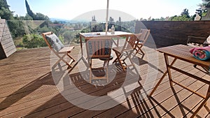 table chairs wooden in wooden balcony with gllass for summer vaccation photo