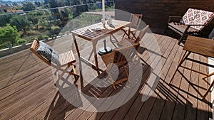 table chairs wooden in wooden balcony with gllass for summer vaccation photo