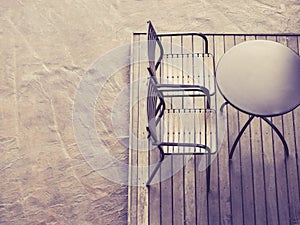 Table with chairs on wooden deck floor outdoor Top view