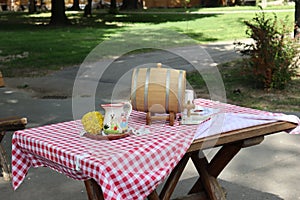 Table with checkered cover and small barrel