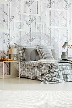 Patterned grey and white bedclothes photo