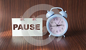 Table clock on a wooden background