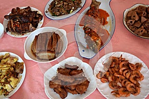 Table covered with many plates with various, delicious and colorful food.