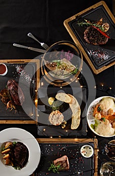 the table is covered with various meat dishes. delicious dishes are prepared for the celebration