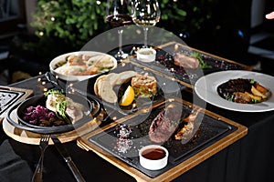 the table is covered with various meat dishes. delicious dishes are prepared for the celebration