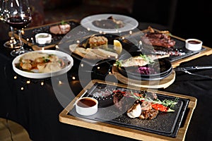 the table is covered with various meat dishes. delicious dishes are prepared for the celebration