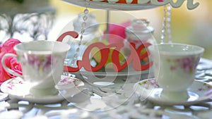 Table with crockery cups plates decorative love wedding entourage