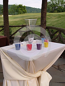 Table and cups of sand for a ceremony