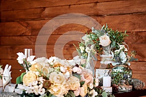 Table decor with white flowers and candles for a wedding party.