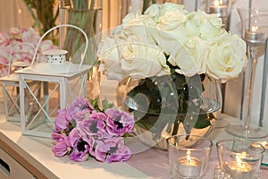 Table decorated with candles and roses