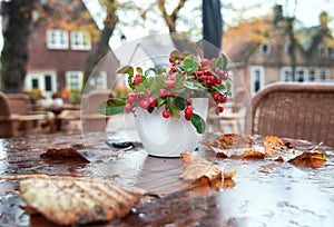 Table decorated with red berries on the terrace of a restaurant
