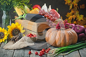 The table, decorated with vegetables, pumpkins and fruits. Harvest Festival, Happy Thanksgiving. Autumn background