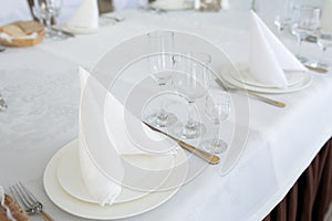 Table with decoration dish cutlery in bright room