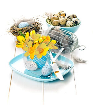 Table decoration with easter eggs nest on plate