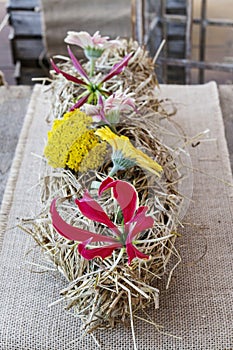 Table decoration with hay and flowers