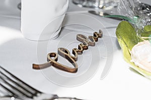 Table decoration of a wedding with glasses of cutlery and the name Claudia, Germany