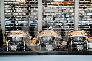 Table with dishware and shiny marmites waiting for guests