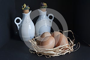 Table with eggs in the straw and oil and vinegar dispenser