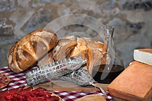 Table on the farm with salami bread wine and local cheeses