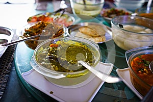 Table filled with fresh homemade gujarati food is seen from above. Traditional indian vegetarian kathiyawadi thali