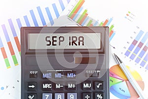 On the table are financial charts and a calculator, on the electronic board of which is written the text - SEP IRA