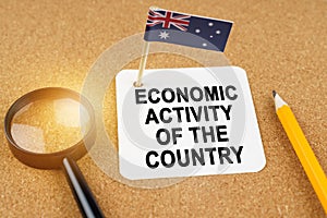 On the table is the flag of Australia and a sheet of paper with the inscription - economic activity of the country