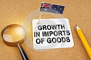 On the table is the flag of Australia and a sheet of paper with the inscription - growth in imports of goods