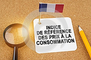 On the table is the flag of France and a sheet of paper with the inscription - core consumer price index