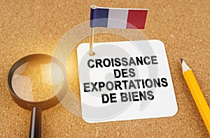 On the table is the flag of France and a sheet of paper with the inscription - growth in exports of goods