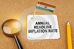 On the table is the flag of India and a sheet of paper with the inscription - Annual headline inflation rate