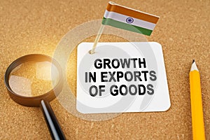 On the table is the flag of India and a sheet of paper with the inscription - growth in exports of goods