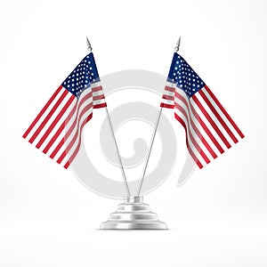 Table flag USA. Two national flags on metal flagpole stand isolated on white photo
