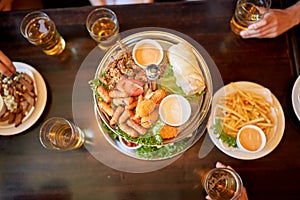 Table with food and beer glasses at bar or pub