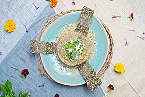 a table with food on blue plates and flower decoration on blue cloth