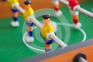 Table football game with yellow and red players and white goalkeeper. Table soccer game.
