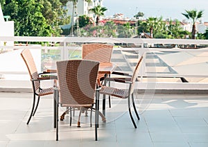 Table with four chairs standing on open air terrace