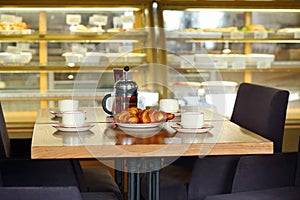 Table with four cups of tea, teapot and fresh