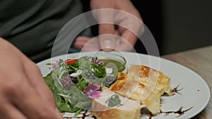 Table with fresh vegetables, spices and chicken roll with spinach