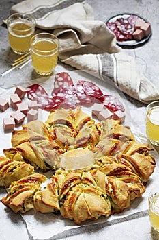 Table for a friendly party, snack star bread with cheese filling, sausage and beer.