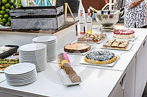 Table full with beautiful and delicious cakes at wedding reception Buffet