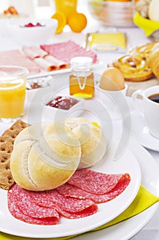 Table full with continental breakfast items, brightly lit